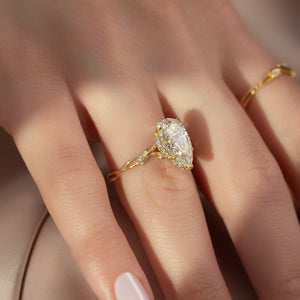 The Halo Twig Set  With A 4.5 Carat Pear 18K Yellow Gold Moissanite